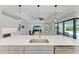 Spacious open concept kitchen with an oversized island, stainless steel appliances, and seamless flow to the living area at 8264 Summer Night Rd, Sarasota, FL 34241
