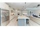 Open kitchen and living room area, featuring white cabinets, quartz countertops, and stainless steel appliances at 8264 Summer Night Rd, Sarasota, FL 34241