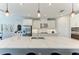 Bright kitchen with a quartz countertop island, stainless steel appliances, and modern pendant lighting at 8264 Summer Night Rd, Sarasota, FL 34241