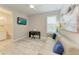 Comfortable living room with a couch, mounted TV, and an adjacent bathroom at 8264 Summer Night Rd, Sarasota, FL 34241