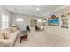 A bright and airy living room features a coffered ceiling and entertainment center with large flat screen TV at 8264 Summer Night Rd, Sarasota, FL 34241