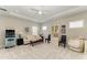 A well lit living room has a sofa, ceiling fan, and coastal decor with a vintage arcade game at 8264 Summer Night Rd, Sarasota, FL 34241