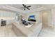 Elegant living room with open concept, light wood floors, and a view of the gourmet kitchen at 8264 Summer Night Rd, Sarasota, FL 34241