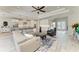 Spacious open-concept living area with a kitchen island, modern lighting, and hardwood floors at 8264 Summer Night Rd, Sarasota, FL 34241