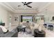 Bright and airy living room with a stylish ceiling fan and sliding doors leading to a pool at 8264 Summer Night Rd, Sarasota, FL 34241