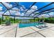 Beautiful pool with screened enclosure and scenic view of the lake and lush greenery at 8264 Summer Night Rd, Sarasota, FL 34241