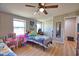 Comfortable bedroom with two beds, ceiling fan, closet, and ample natural light, creating a cozy and inviting space at 8725 Aero Ave, North Port, FL 34287