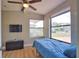 Bright bedroom featuring light-colored walls, fan, and a large window offering ample natural light and neighborhood views at 8725 Aero Ave, North Port, FL 34287