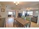 Open-concept dining area showcases a wooden table, bench seating, and adjacent stainless steel kitchen appliances at 8725 Aero Ave, North Port, FL 34287