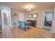 Bright dining area with a table, chairs, and ample space for gatherings, adjacent to a full bathroom at 8725 Aero Ave, North Port, FL 34287