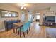Well-lit dining room featuring a modern chandelier, seating for four, and an open layout to the kitchen at 8725 Aero Ave, North Port, FL 34287
