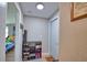 Hallway with decorative shoe storage, leading to a bedroom filled with natural light and colorful decor at 8725 Aero Ave, North Port, FL 34287