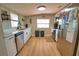 Modern kitchen featuring white cabinets, stainless steel appliances, light countertops, and ample natural light at 8725 Aero Ave, North Port, FL 34287