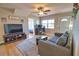 A versatile living room blends relaxation and work, showcasing wood-look floors and a comfortable seating area at 8725 Aero Ave, North Port, FL 34287