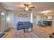Inviting living room with a comfortable sofa, modern ceiling fan, and stylish decor, creating a cozy atmosphere at 8725 Aero Ave, North Port, FL 34287