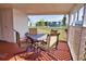 Covered patio features a metal table and chairs with view to backyard at 8725 Aero Ave, North Port, FL 34287