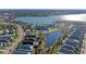 An aerial view showcases the community's amenities, including the pool and clubhouse, by the lake at 909 Crosswind Ave, Sarasota, FL 34240