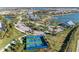 An aerial view showcases the pickleball court and other community amenities near the lake at 909 Crosswind Ave, Sarasota, FL 34240