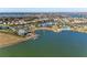 Aerial shot of a lakeside community with lush greenery, amenities, and stunning waterfront homes at 909 Crosswind Ave, Sarasota, FL 34240