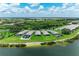 An aerial view showcases waterfront homes, lush landscaping, and the community's serene setting at 909 Crosswind Ave, Sarasota, FL 34240