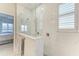 Modern bathroom showcasing a glass-enclosed shower with a view of the bedroom and waterfront at 909 Crosswind Ave, Sarasota, FL 34240