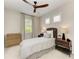Well-lit bedroom with modern ceiling fan, side tables, and natural light at 909 Crosswind Ave, Sarasota, FL 34240