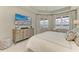 Serene bedroom with large windows offering picturesque lake views, complemented by elegant furnishings at 909 Crosswind Ave, Sarasota, FL 34240