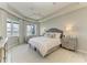 Serene bedroom with tray ceiling, lots of natural light, a neutral color palette, and stylish furnishings at 909 Crosswind Ave, Sarasota, FL 34240
