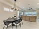 Bright and airy dining room with a modern chandelier, large windows, and a view of the lake at 909 Crosswind Ave, Sarasota, FL 34240