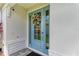 Close-up of an inviting blue front door with decorative wreath, sidelights, and modern hardware at 909 Crosswind Ave, Sarasota, FL 34240