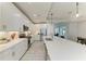 Open concept kitchen with a large island, stainless steel appliances, white cabinets, and sleek countertops at 909 Crosswind Ave, Sarasota, FL 34240