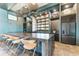 Modern kitchen featuring a large granite island with bar seating and stainless steel appliances at 909 Crosswind Ave, Sarasota, FL 34240