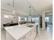 Open concept kitchen features a large island with seating, stainless steel appliances, and modern finishes at 909 Crosswind Ave, Sarasota, FL 34240