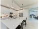 Modern kitchen showcases an oversized island, stainless steel appliances, white cabinets, and bar stool seating at 909 Crosswind Ave, Sarasota, FL 34240