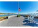 Outdoor brick patio featuring a picturesque view of the lake and two chairs at 909 Crosswind Ave, Sarasota, FL 34240