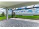 Screened lanai with brick flooring offering beautiful views of the lake at 909 Crosswind Ave, Sarasota, FL 34240