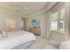 Tranquil bedroom featuring natural light, tray ceiling, neutral decor, and an ensuite bathroom at 909 Crosswind Ave, Sarasota, FL 34240