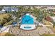 Aerial view of a large community pool surrounded by palm trees, lounge chairs, and rock features at 909 Crosswind Ave, Sarasota, FL 34240