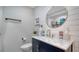 Stylish bathroom with a modern vanity, shiplap wall, and elegant mirror at 946 N Beneva Rd # V26, Sarasota, FL 34232