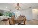 Open-concept dining room with chandelier, wood table, and access to the living area at 946 N Beneva Rd # V26, Sarasota, FL 34232