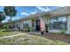 Charming single-story home featuring a cozy porch and lush landscaping at 946 N Beneva Rd # V26, Sarasota, FL 34232