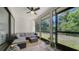 Covered lanai with comfortable seating and a view of the lush, green backyard at 946 N Beneva Rd # V26, Sarasota, FL 34232