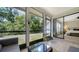 Screened lanai showcasing a view of the backyard and access to the bedroom at 946 N Beneva Rd # V26, Sarasota, FL 34232