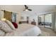 Bright main bedroom with a ceiling fan, slider to the patio, and an ensuite bathroom at 946 N Beneva Rd # V26, Sarasota, FL 34232