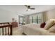 Bright main bedroom boasts a ceiling fan, a large window with blinds, and wood-look floors at 946 N Beneva Rd # V26, Sarasota, FL 34232