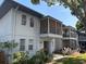View of condo balconies with neutral awnings and green lawns; toys are visible in one yard at 10800 N Us Highway 19 # 237, Pinellas Park, FL 33782