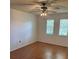 Well-lit bedroom with hardwood floors, ceiling fan, and two windows at 10800 N Us Highway 19 # 237, Pinellas Park, FL 33782