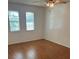 Bedroom featuring wood floors and two windows at 10800 N Us Highway 19 # 237, Pinellas Park, FL 33782