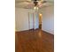 Bright bedroom with hardwood floors, closet, and a view to the bathroom at 10800 N Us Highway 19 # 237, Pinellas Park, FL 33782