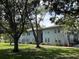 Well-maintained two-story condo building with mature trees and landscaping in a verdant community at 10800 N Us Highway 19 # 237, Pinellas Park, FL 33782